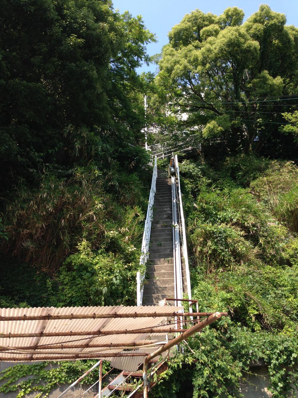 Local appearance photo. Is a staircase to climb from the property south to the building.