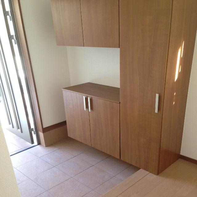 Entrance. It is the front door with a shoe box. 