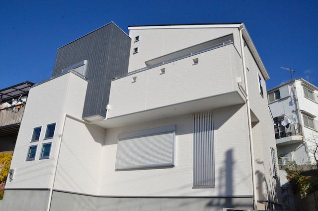 Local appearance photo. Dazzling new building detached in blue sky