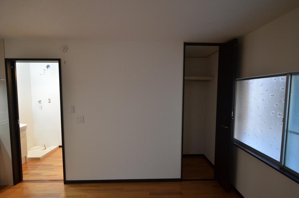 Receipt. Living of storage space looks to the right. There is a toilet on the left.