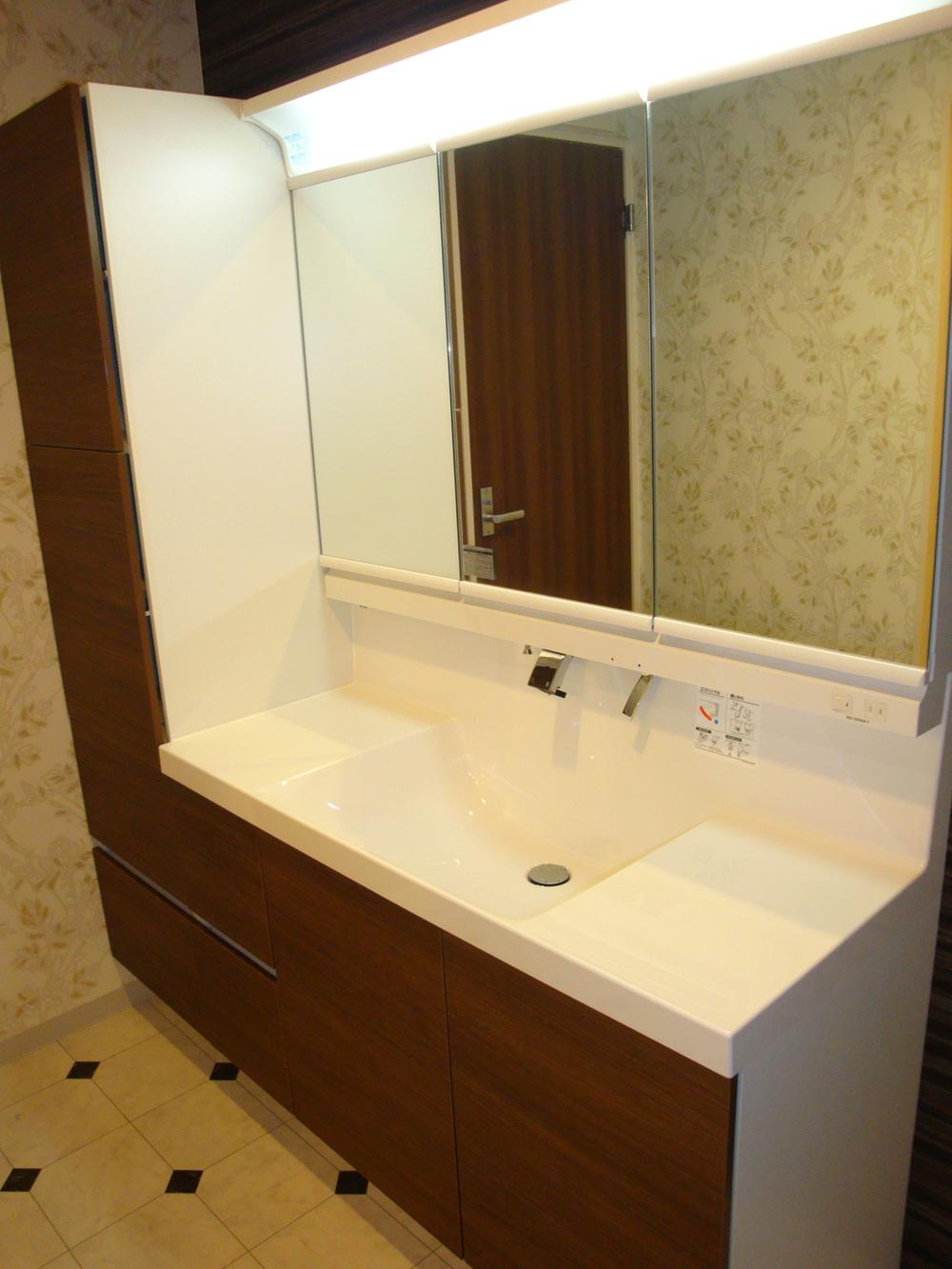 Wash basin, toilet. Vanity and linen cabinet