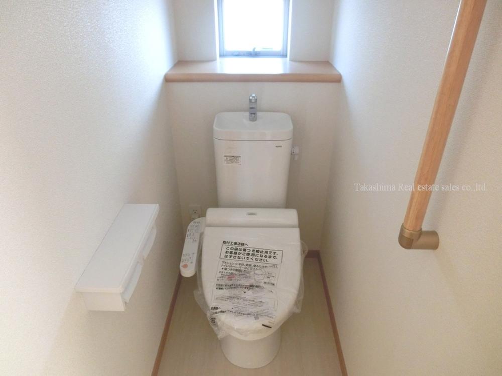 Toilet. Handrail with toilet.