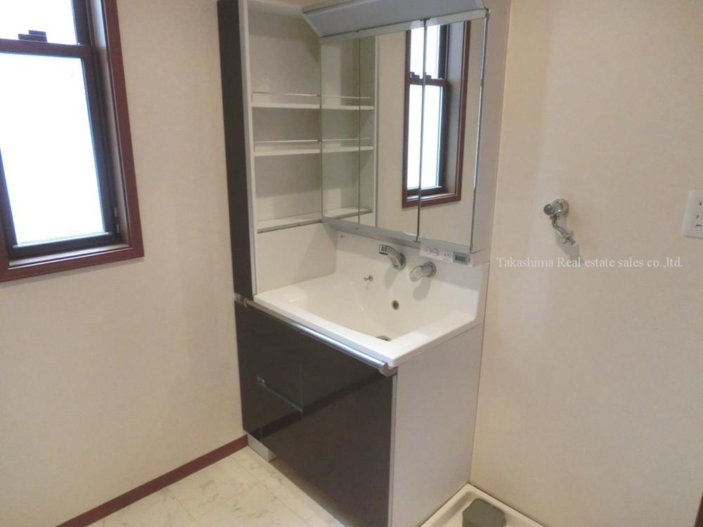 Wash basin, toilet. Wash basin with a tall cabinet.