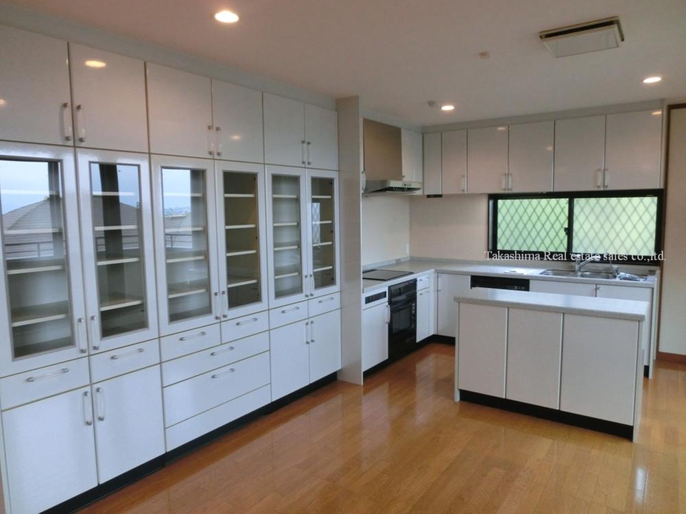 Kitchen. Island deck kitchen is in an L-shape. Cup board is oversized.