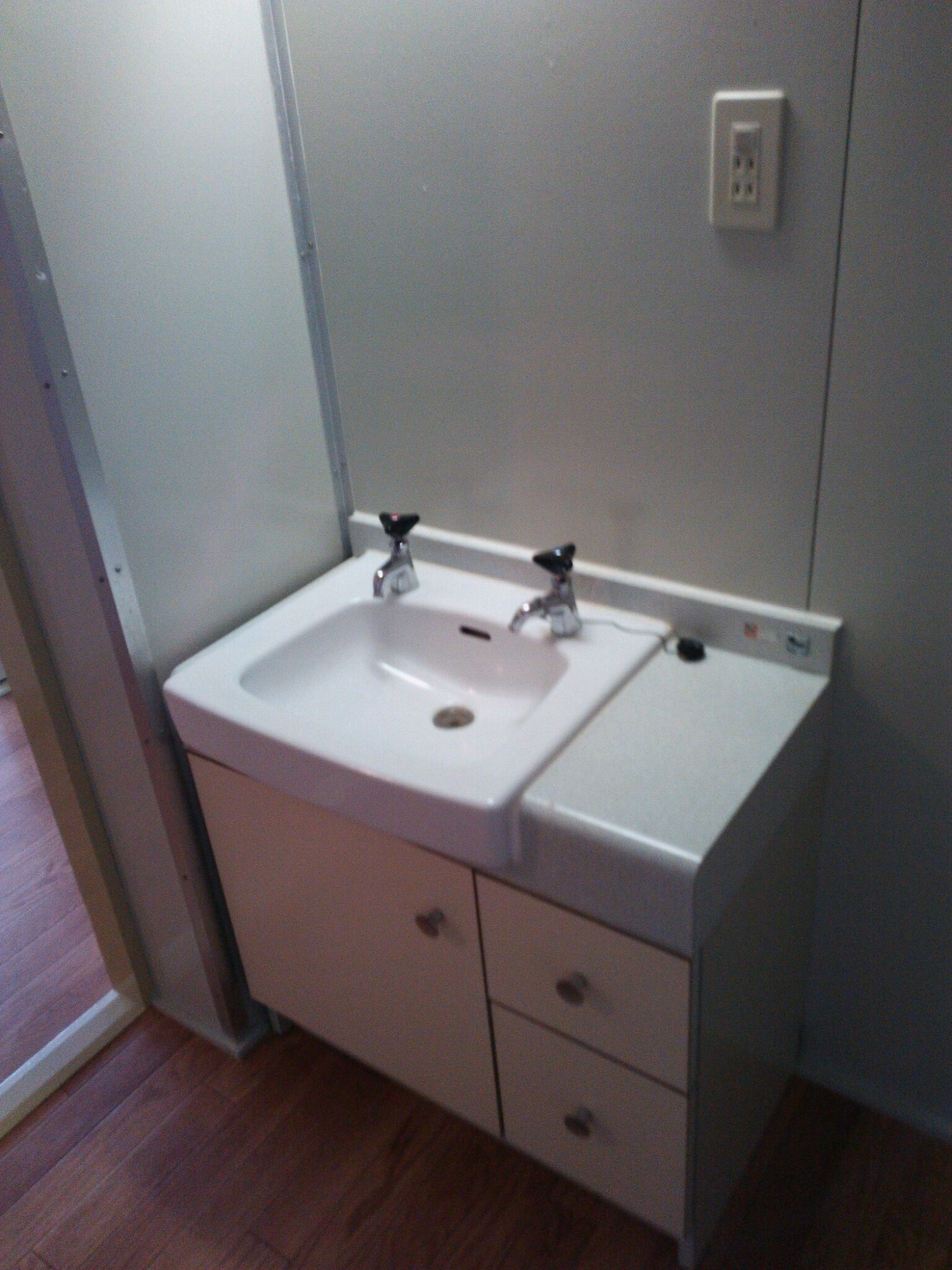 Washroom. Compact wash basin with a clean feeling with storage box