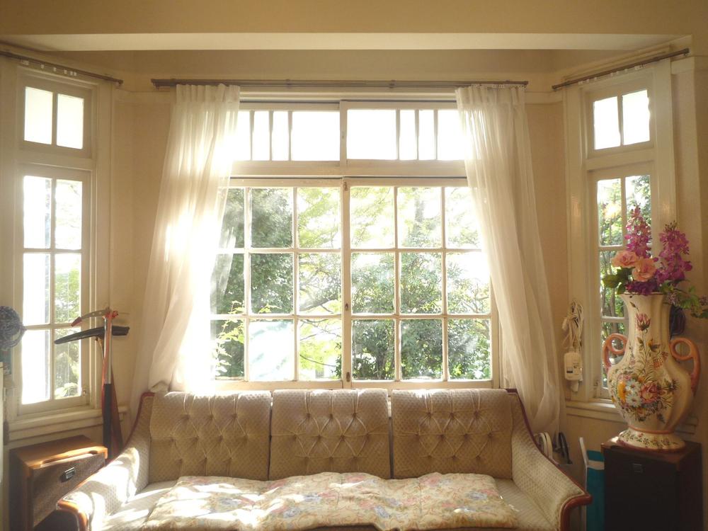 Living. Soft sunshine filtering through foliage will rain down from the living room the south side of the bay window.