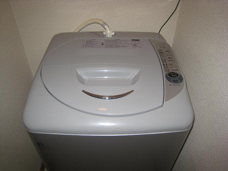 Other Equipment. There is a washing machine in a room.