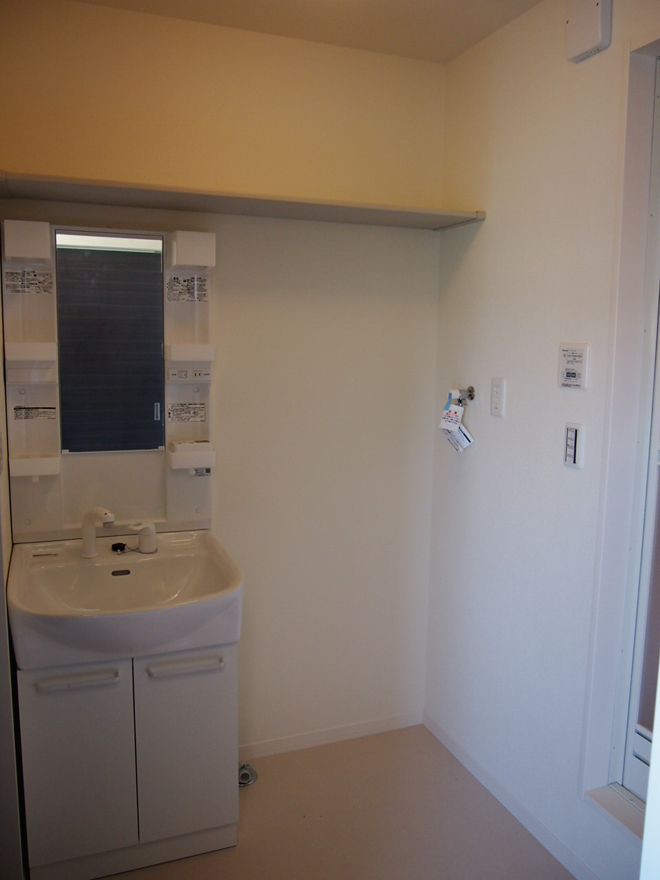 Washroom. Shampoo dresser and a washing machine inside the yard