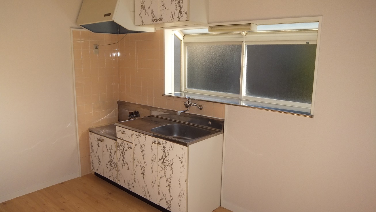 Kitchen. There is a window is bright kitchen. 