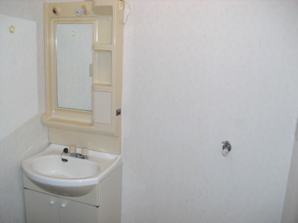 Washroom. Wash basin next to is the Laundry Area.