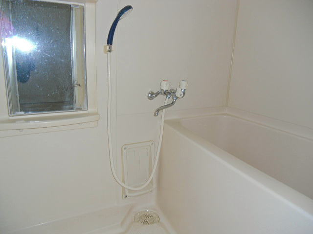 Bath. Is a compact bath the mirror is attached.