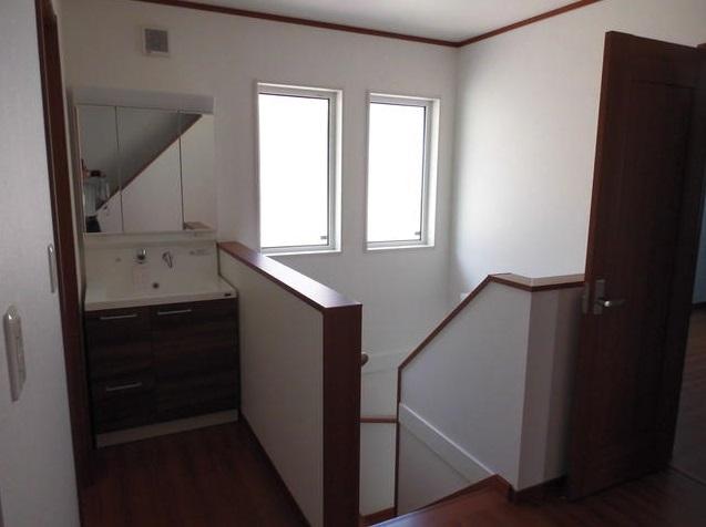 Wash basin, toilet. Vanity is also on the second floor