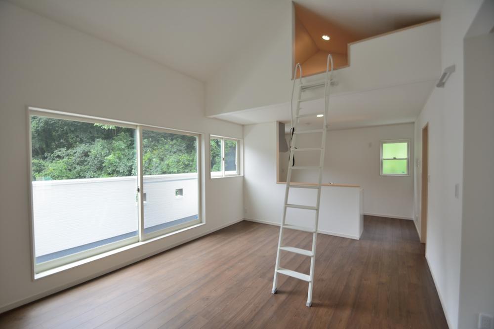 Living. Second floor living room with a loft. Brown floor to the white wall of, Beautiful green scenery from the window.