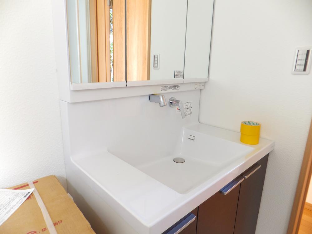 Wash basin, toilet. It is vanity of large.