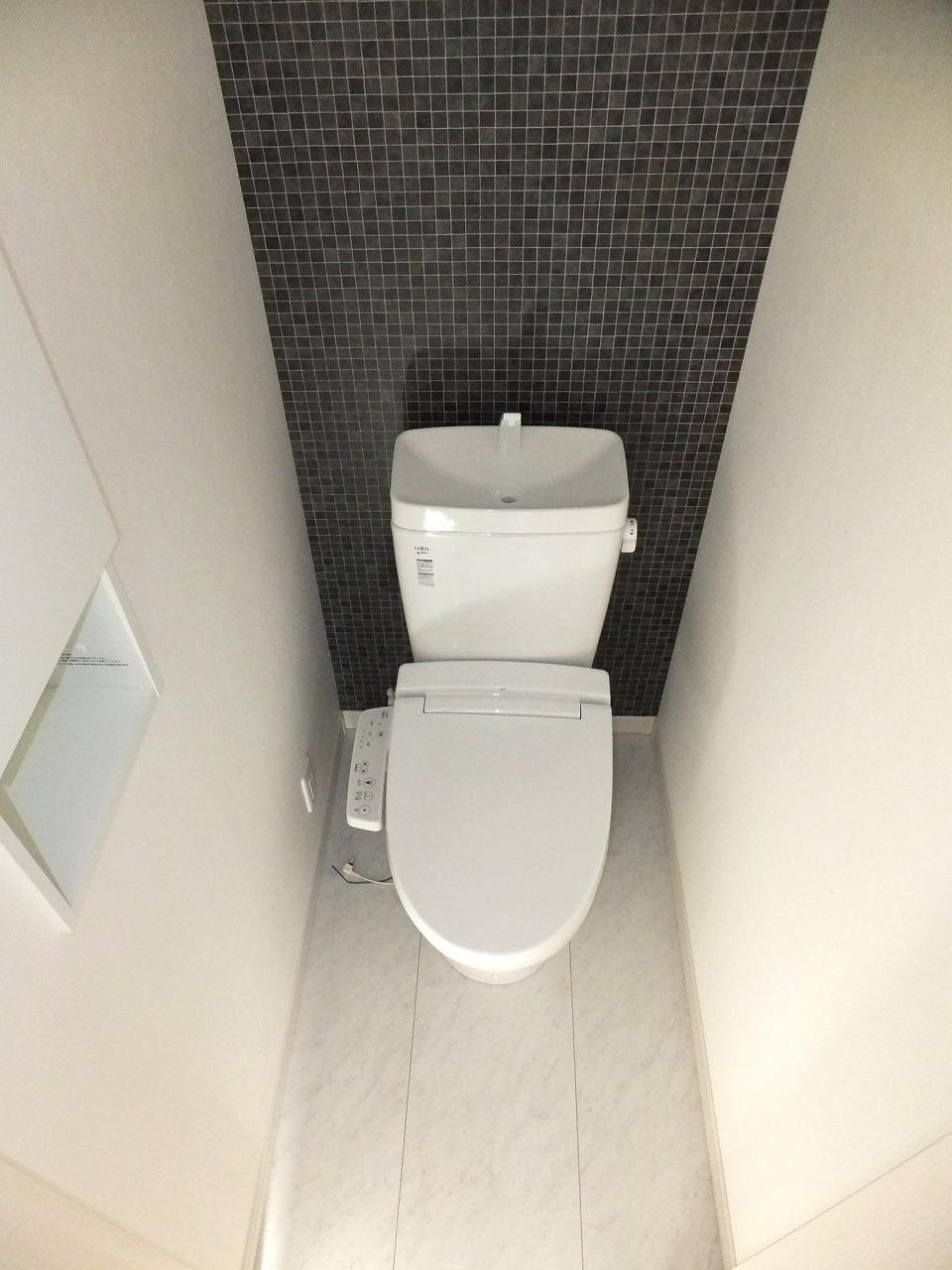 Toilet. It is a warm water washing toilet seat.