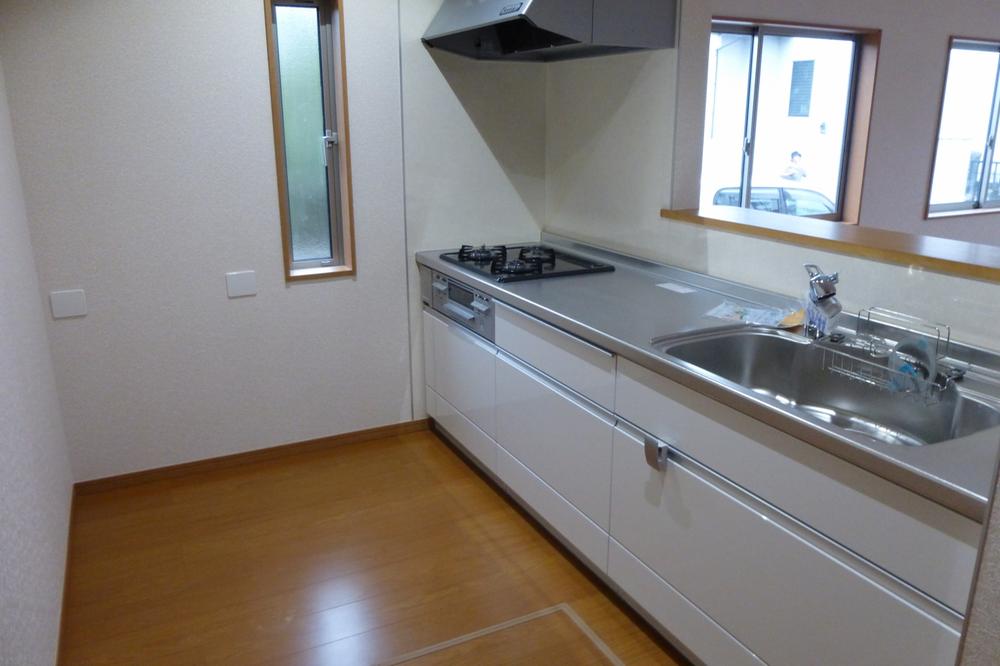Kitchen. Enter the bright sunlight small window + under-floor storage!