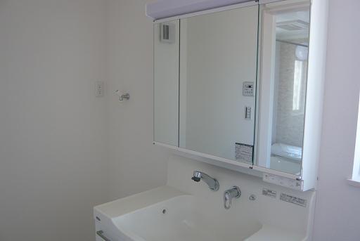 Wash basin, toilet. Bright washroom!