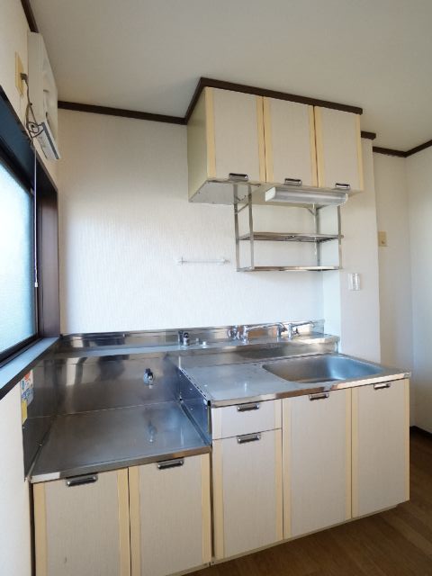 Kitchen. With hanging cupboard, With bright window