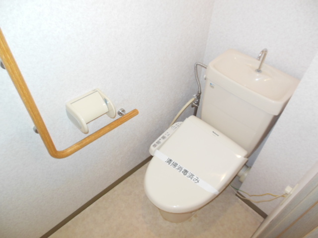 Toilet. There are also railing to the toilet