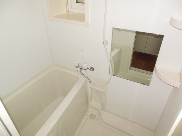 Bath. It is a bathroom with a small window