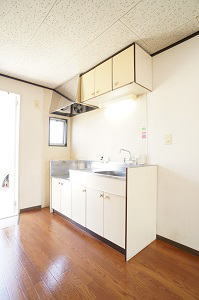 Kitchen. There is a sink next to a small window