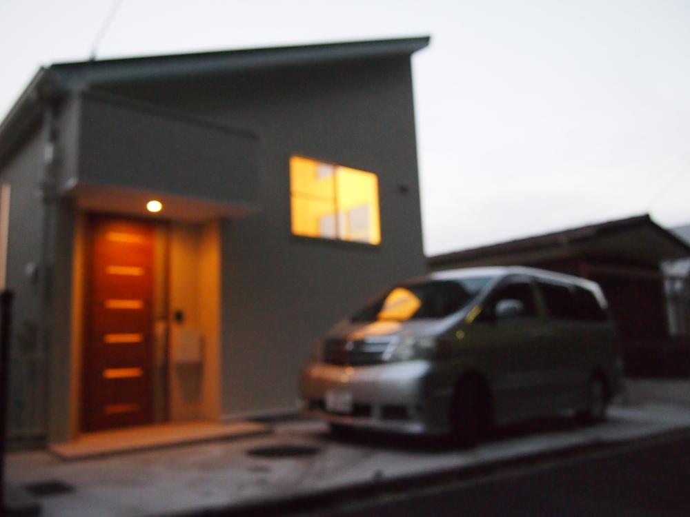 Local appearance photo. Entrance door and parking space