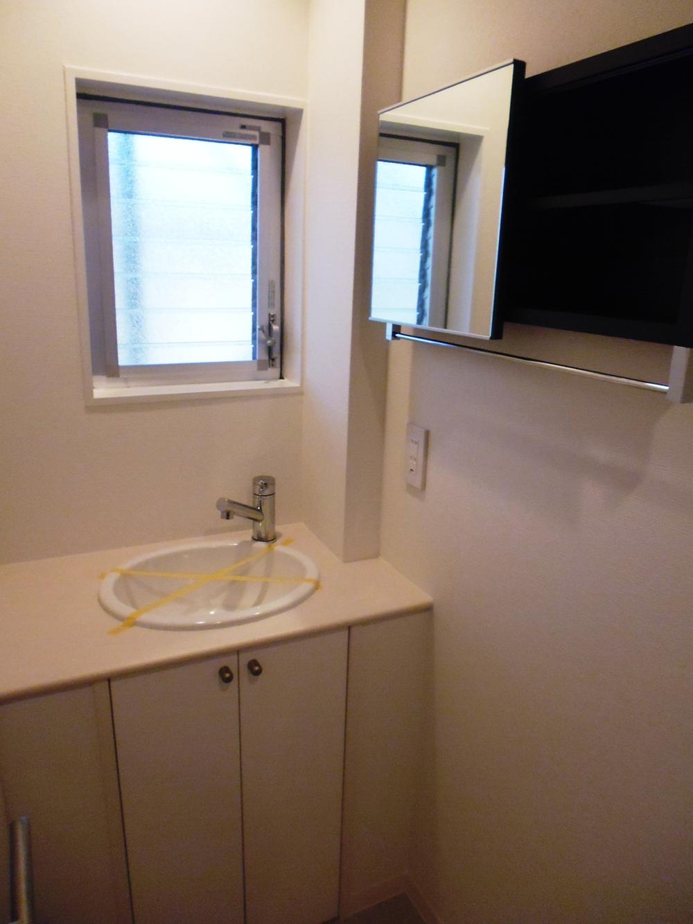 Wash basin, toilet. Window with wash basin