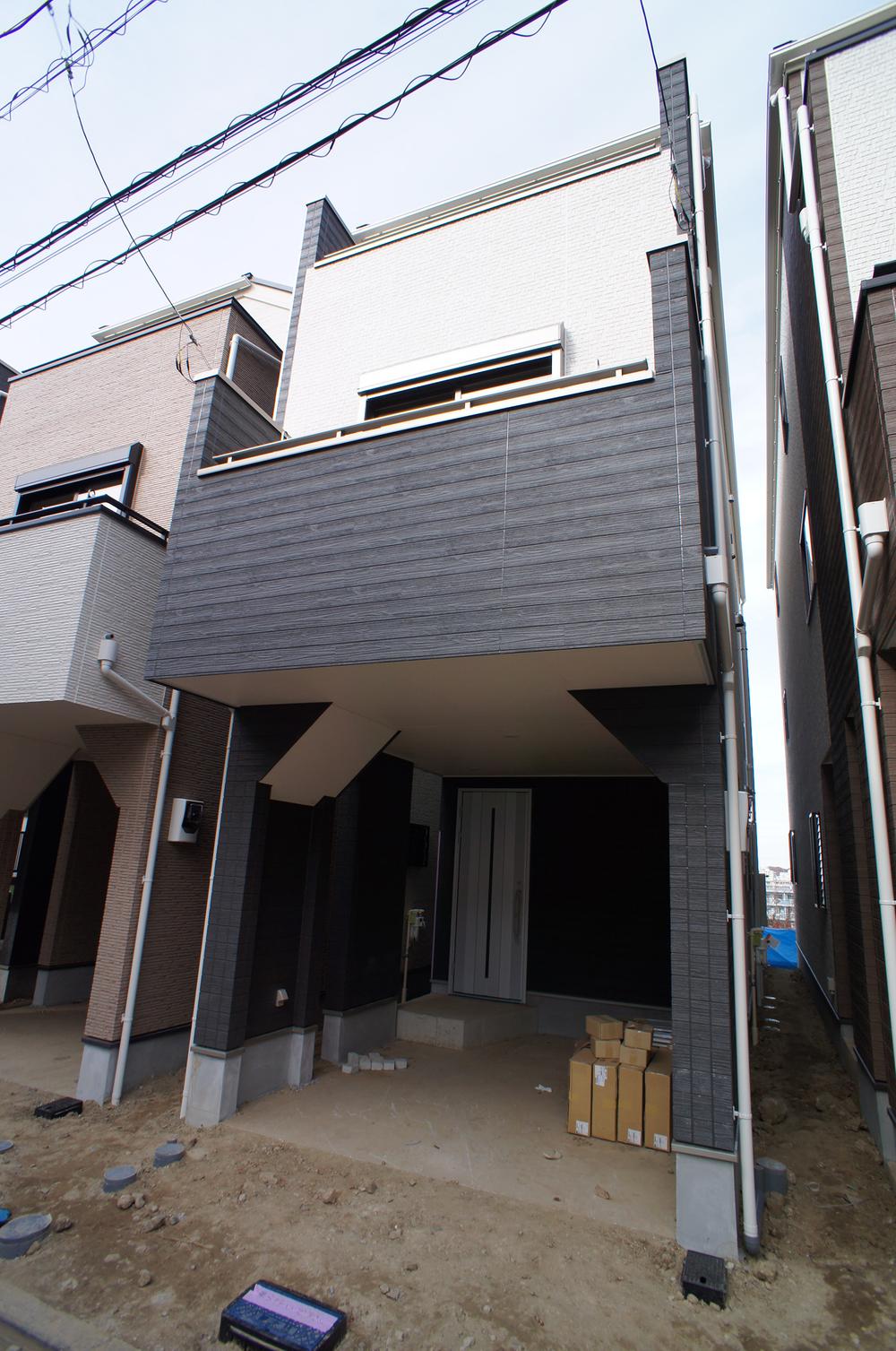 Local appearance photo. It is a three-story house with a garage on the first floor