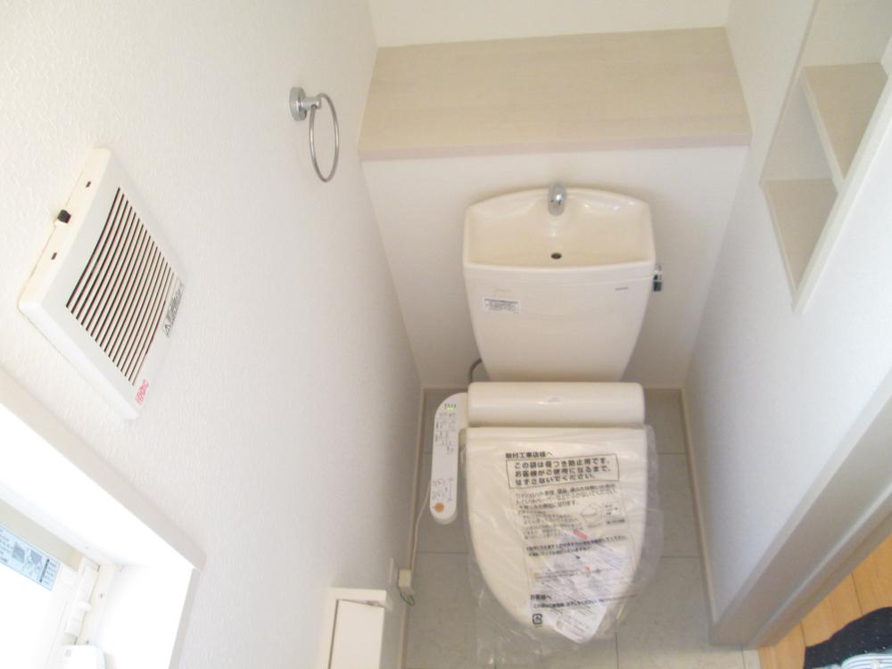 Toilet. The toilet also has a small storage and window