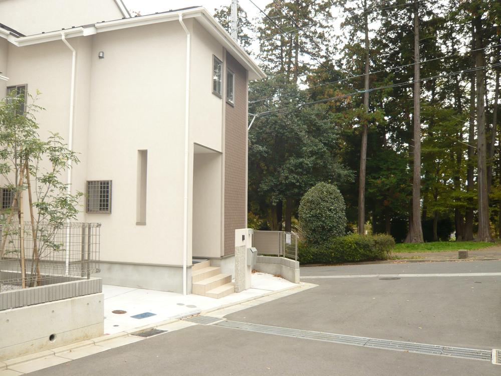 Local appearance photo. There is a park surrounded by green next to across the road