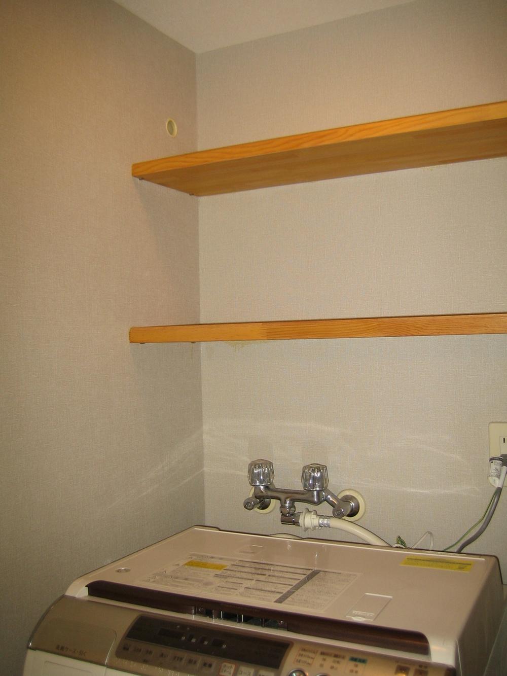Wash basin, toilet. Washroom top shelf