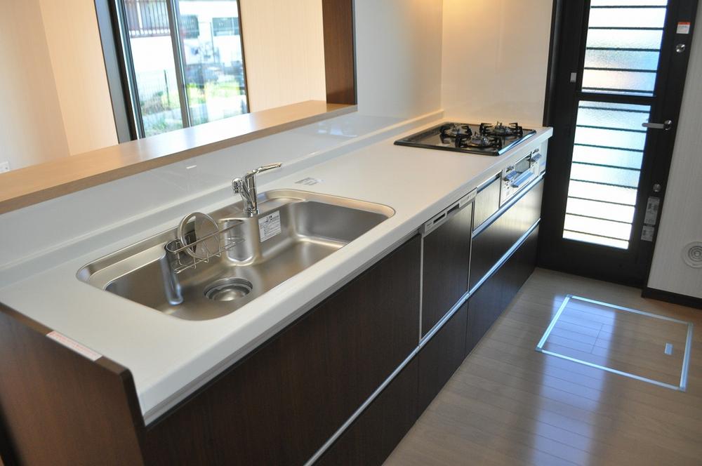 Kitchen. There is also a back door, This face-to-face kitchen with a dishwasher.