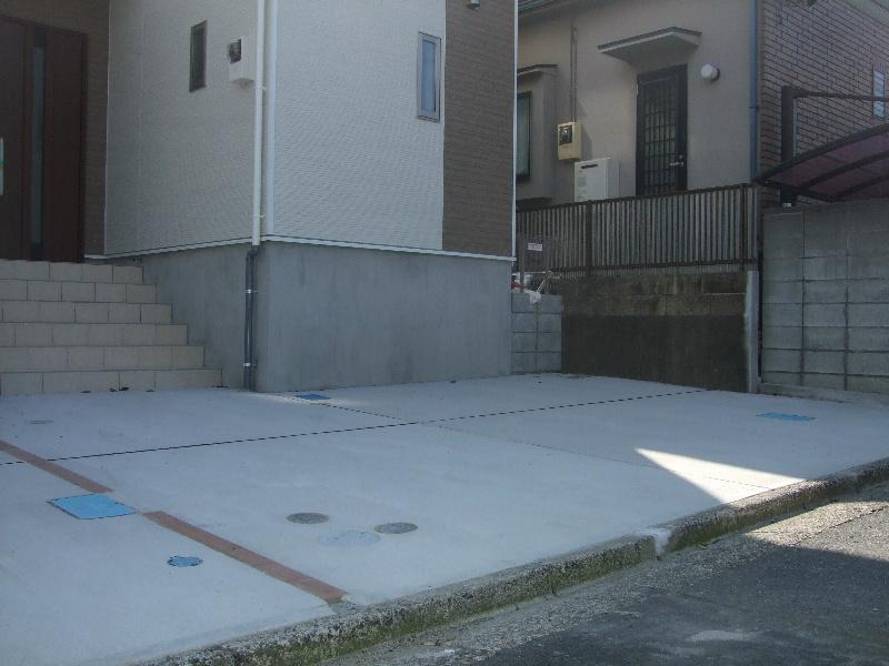 Parking lot. There are two cars car space. 