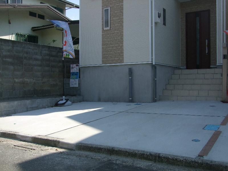 Parking lot. There are two cars car space. 