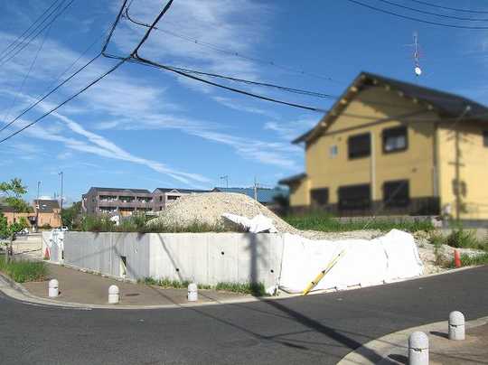 Local land photo. Southwest corner lot. Existing retaining wall will be dismantled.