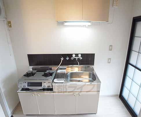 Kitchen. It has a two-necked stove installation.