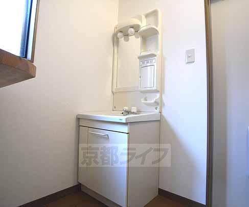 Washroom. There is a wash basin next to the kitchen.