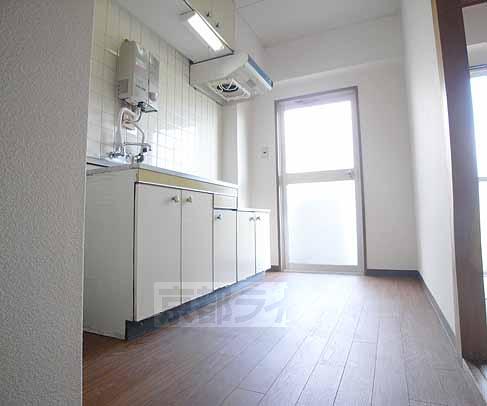 Living and room. It is around the kitchen.