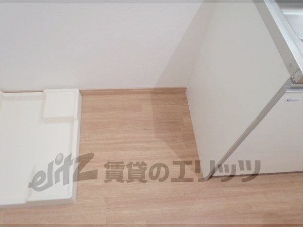 Other room space. Refrigerator next to the kitchen