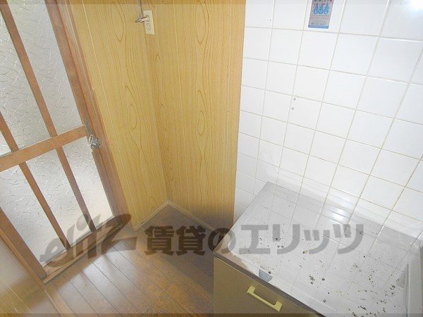 Other room space. A refrigerator is put next to the kitchen table.