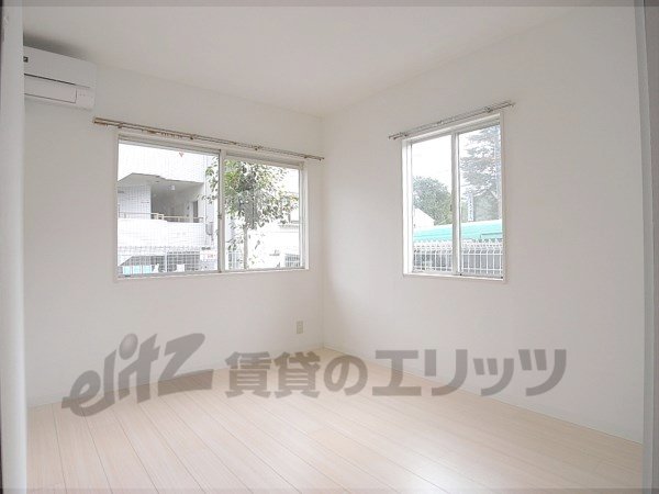 Living and room. There windows two sides, It is a bright room