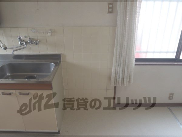 Other room space. A refrigerator is put next to the kitchen table.