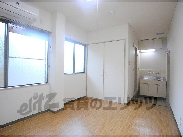 Living and room. There windows two sides, It is a bright room