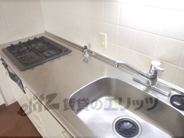 Kitchen. It is a three-necked spacious kitchen with stove.