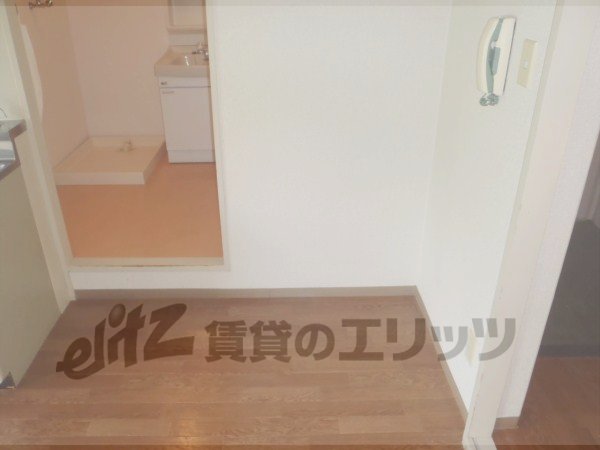 Other room space. A refrigerator is put beside the kitchen table.