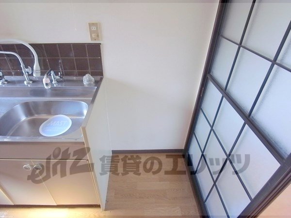 Other room space. A refrigerator is put next to the kitchen table.