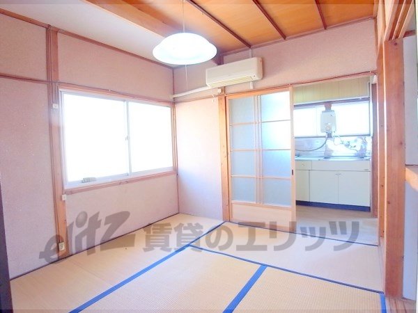 Living and room. There is a partition door between the kitchen.