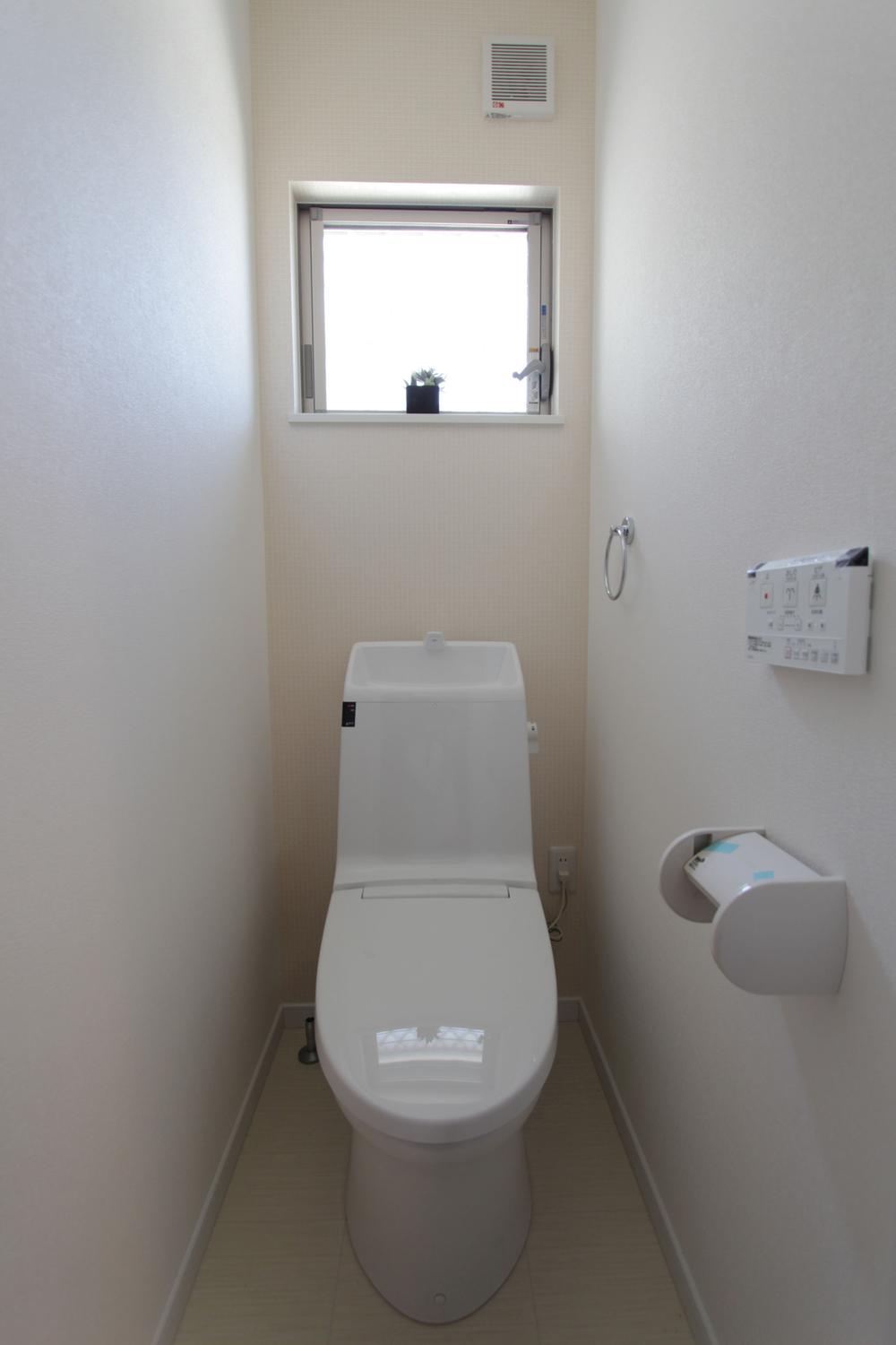 Toilet. Unified toilet with a white wall