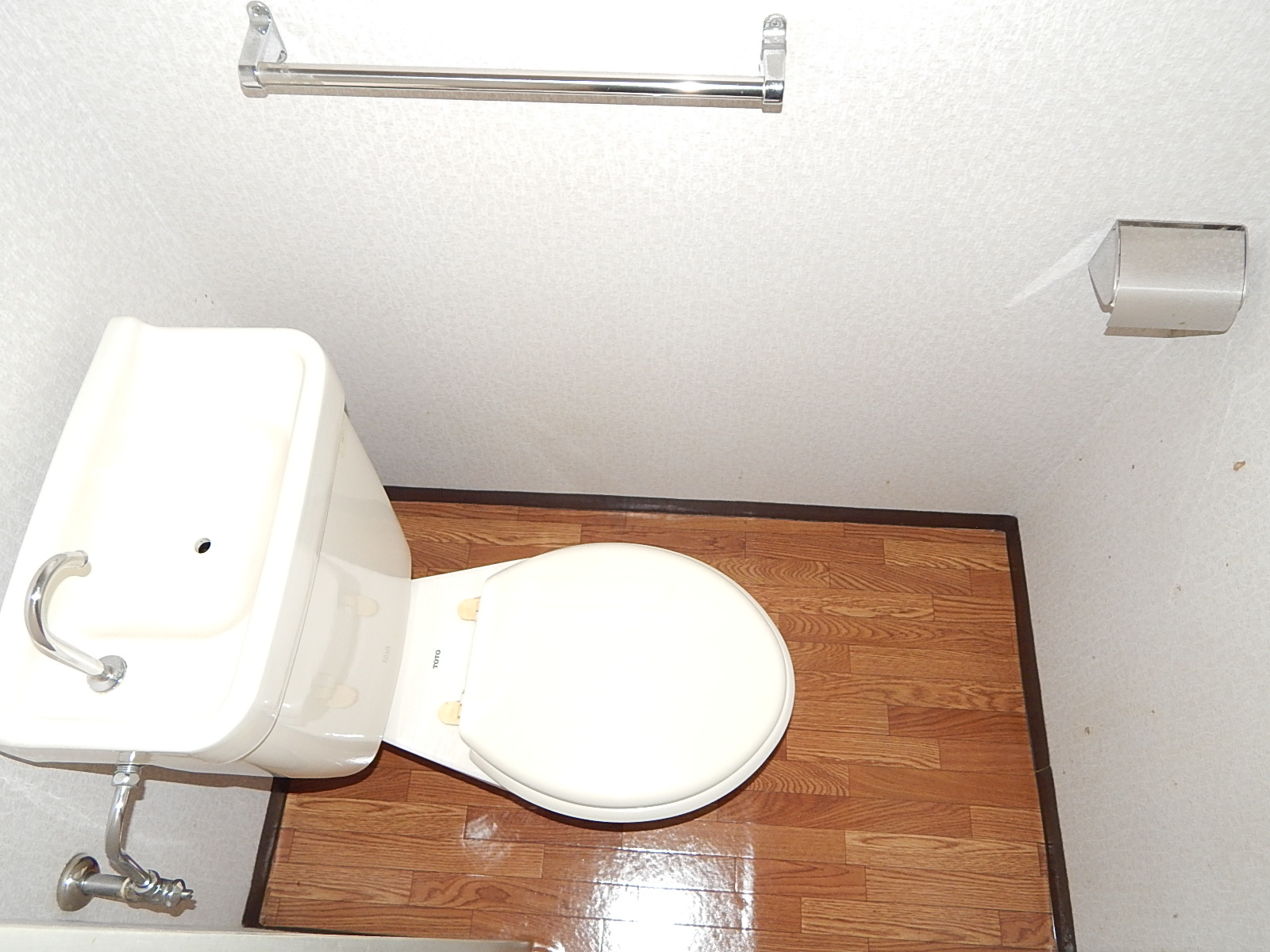 Toilet. Towel over it is equipped with a