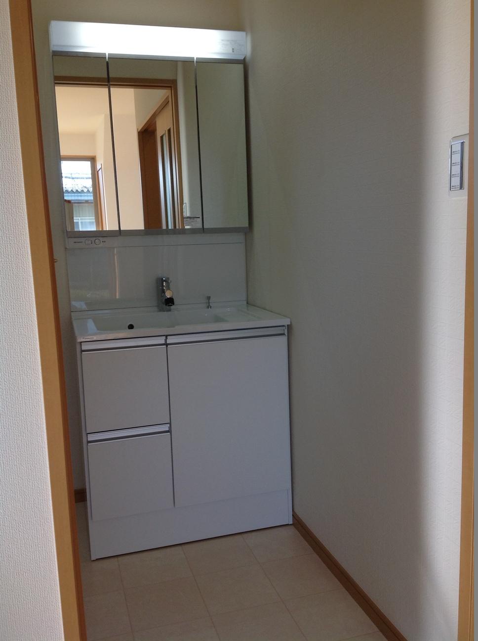Wash basin, toilet. The back of the shower faucet with a three-sided mirror is all housed!